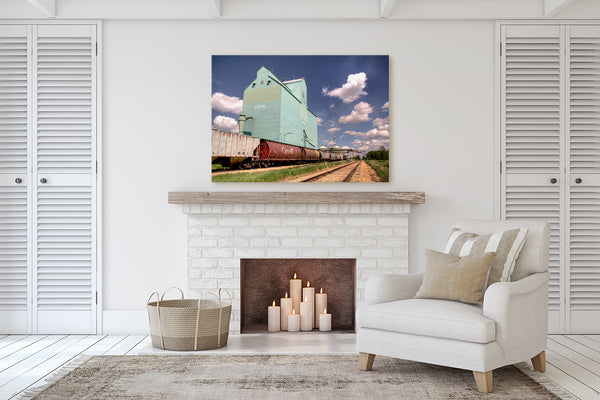 Canvas print of Grain Elevator in Legal hanging in living room with a fireplace.