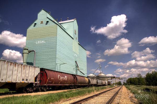 Picture of grain elevator in Legal, Alberta with a Canada hopper car parked on train tracks.